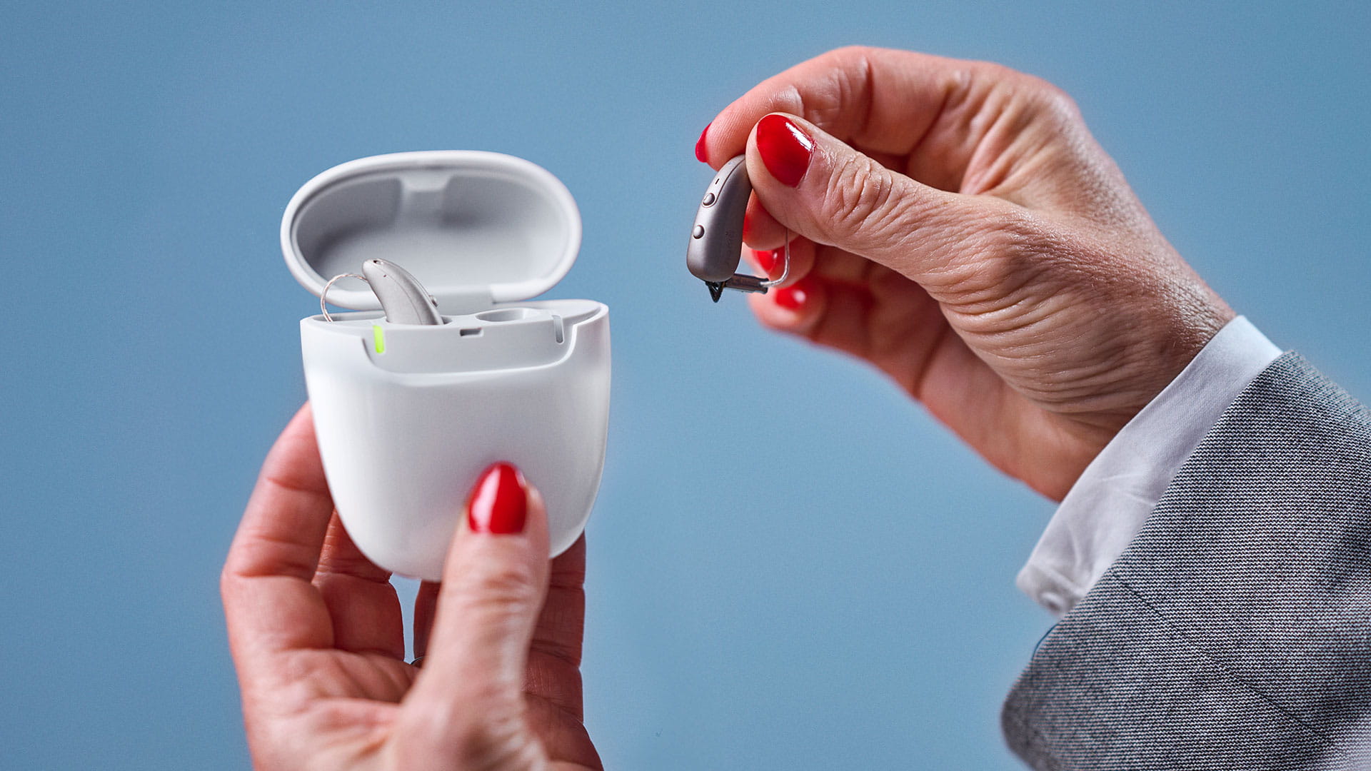 Signia hearing aid being placed in portable charger